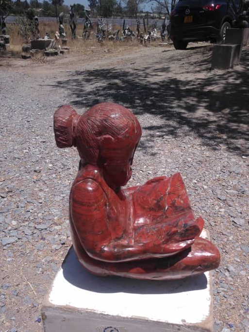 Study Time - Stone Sculpture Made of Red Jasper by Jonathan Mhondorohuma | Zimbabwe