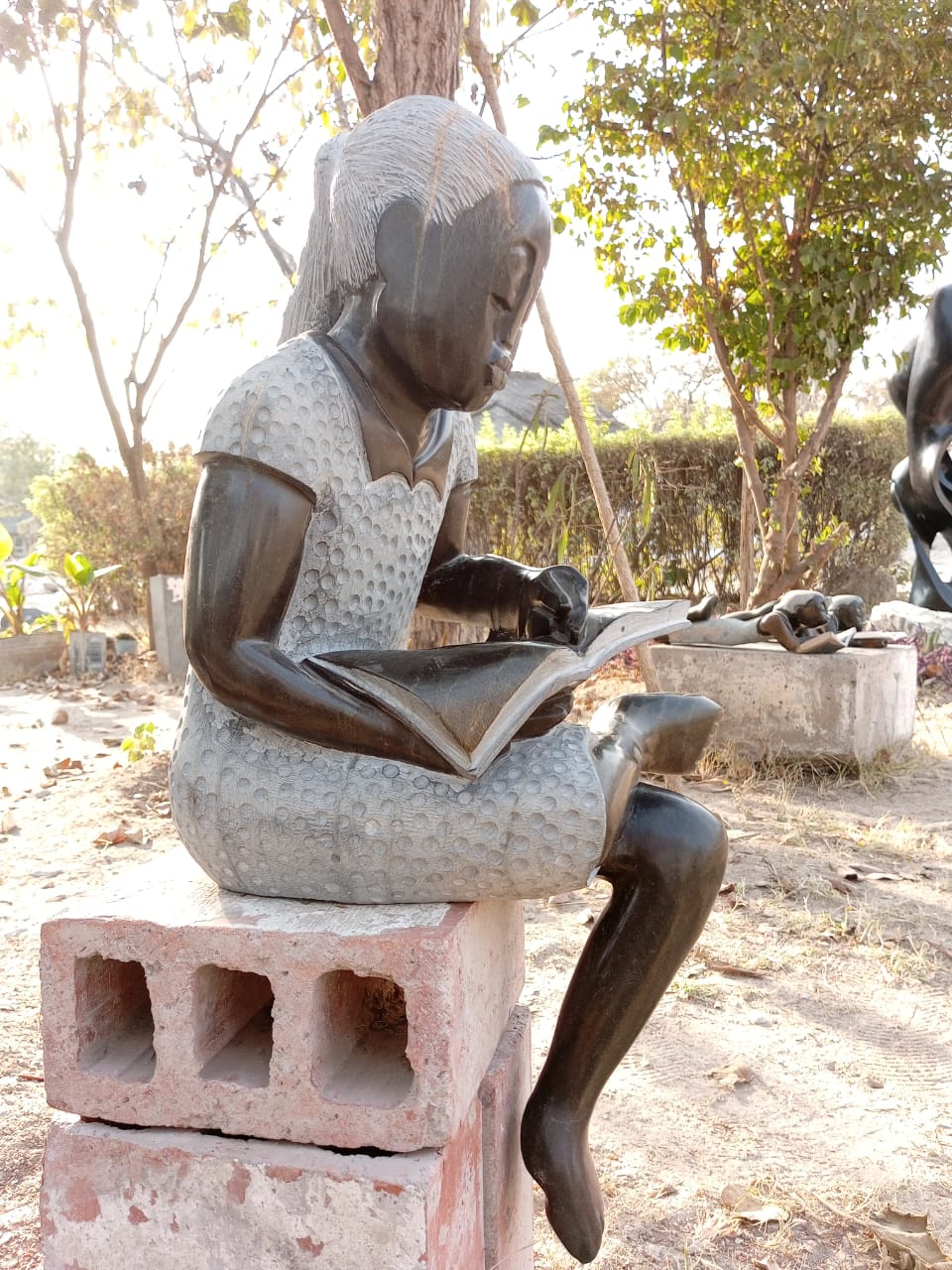 Book Reader - Stone Sculpture Made of Springstone by Jonathan Mondorahuma | Zimbabwe